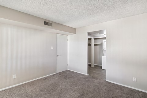 an empty living room with white walls and a carpeted floor